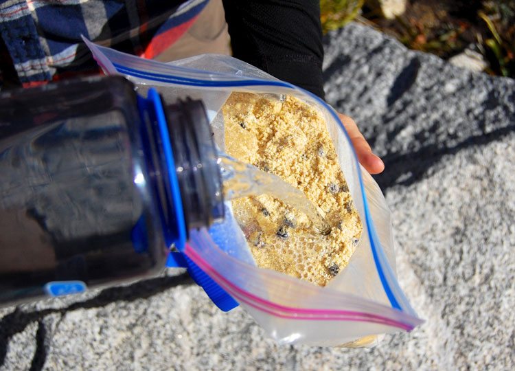 Adding water to Blueberry Cornmeal Pancake batter