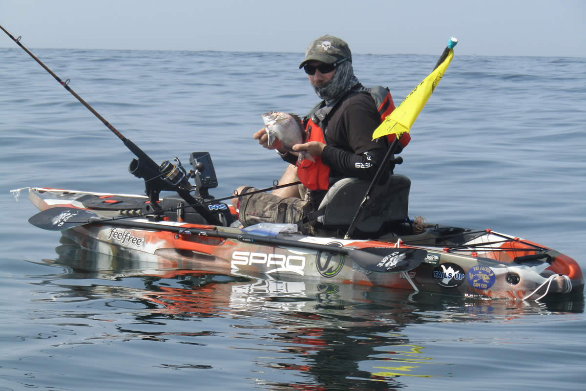Kayak angler Ryan Dubay in a well equipped, well balanced kayak with a safety flag