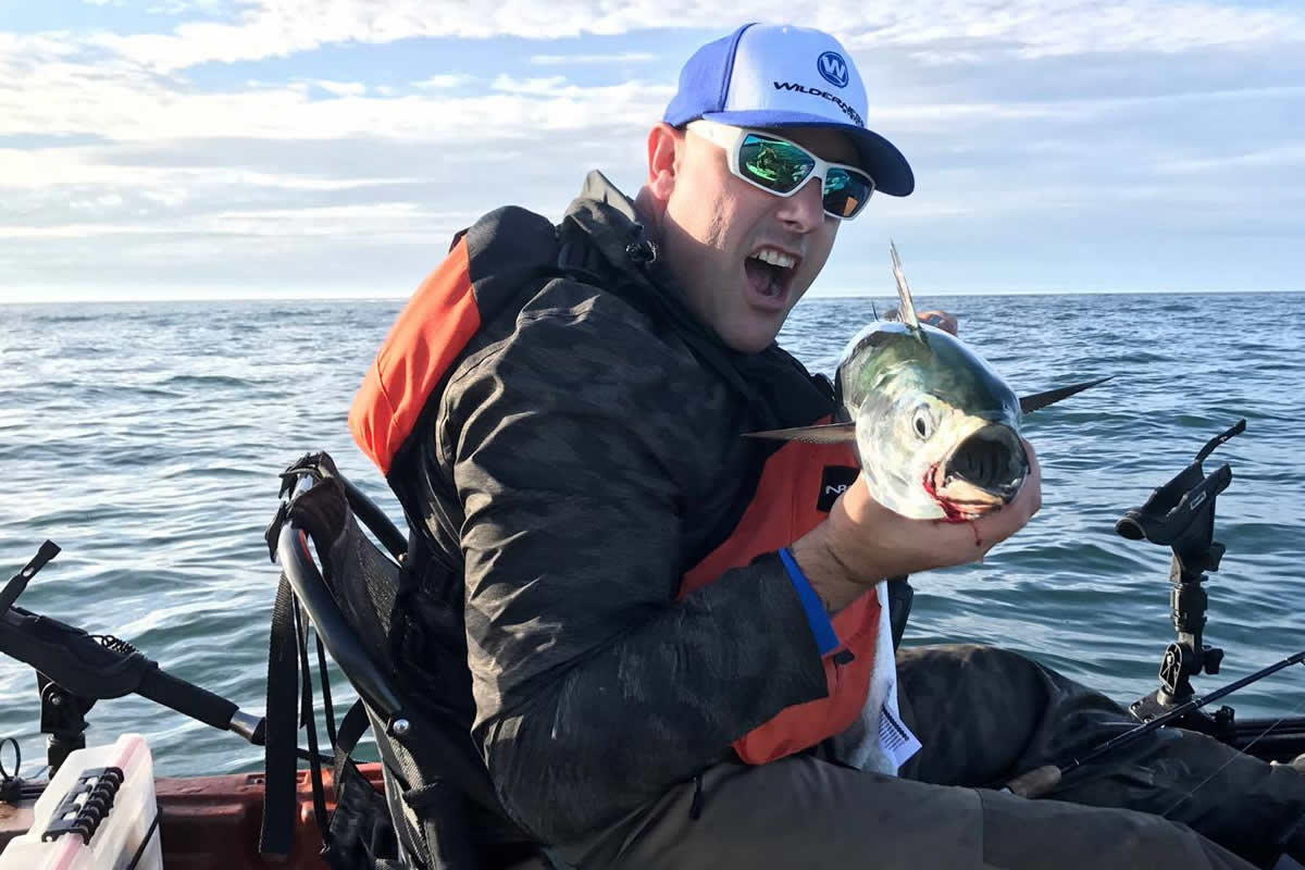 Tom Adams grins from his Wilderness Systems kayak with a fine Fall false albacore