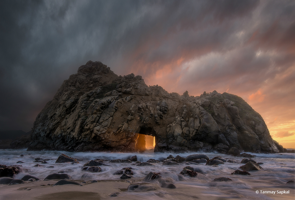 Today’s Photo Of The Day is “Gods Descending” by Tanmay Sapkal. Location: Keyhole Arch, Pfieffer Beach, California.